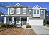 Two-story house with gray siding, stone accents, and a two-car garage at 3149 Bramble Glen Dr., Myrtle Beach, SC 29579