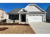 Charming one-story house with gray siding, white trim, and a two-car garage at 916 Anemone Ct Nw, Calabash, NC 28467