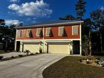 Two-unit building with attached garages, and landscaped yards at 110 Hallandale Lane # Right, Murrells Inlet, SC 29576