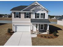Two-story home with stone accents, a two-car garage, black shutters, and a well-manicured front yard at 1026 Jase Dr., Longs, SC 29568