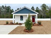 Charming one-story house with a red door and white siding at 230 Ashworth Dr., Tabor City, NC 28463