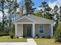 Charming single-story home with neutral siding, green door, and well-maintained landscaping at 244 Ashworth Dr., Tabor City, NC 28463