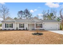 Charming single-story home with light gray siding, black shutters, and a well-maintained front lawn at 815 Lakeside Dr., Georgetown, SC 29440