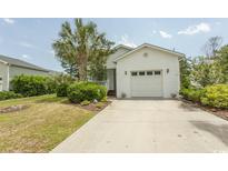 Charming home with a well-maintained lawn, lush landscaping, and a two-car garage at 340 Walden Lake Rd., Conway, SC 29526