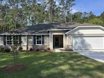 Charming single-story home with a well-manicured lawn and an attached two-car garage at 190 Joanna Gillard Ln., Georgetown, SC 29440