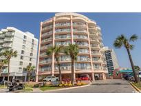 Multi-story beachfront condo building with balconies, palm trees, and convenient covered parking at 202 70Th Ave. N # 104, Myrtle Beach, SC 29572