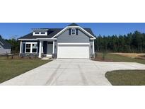 Charming home featuring gray siding, stone accents, and a spacious two-car garage at 4753 Huckleberry Ln., Conway, SC 29526