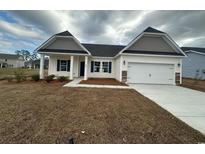 Charming one-story home with a two-car garage, manicured lawn, and welcoming facade at 582 Honeyhill Loop, Conway, SC 29526