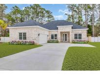 Charming brick home with a well-manicured lawn and inviting front entrance at 277 Waterfall Circle, Little River, SC 29566