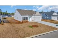 Charming single-story home with white siding, a two-car garage, and manicured front yard at 329 Palmetto Sand Loop, Conway, SC 29527