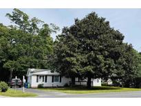 Charming single-story home featuring a well-maintained lawn and mature shade trees at 704 9Th Ave. S, Myrtle Beach, SC 29577