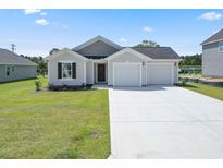 Charming single Gathering home featuring a two-car garage and large driveway and well-manicured lawn at 1061 Kinness Dr., Conway, SC 29527