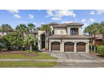 Stately Mediterranean home boasts a tile roof, a three-car garage, and lush landscaping at 1549 Serena Dr., Myrtle Beach, SC 29579