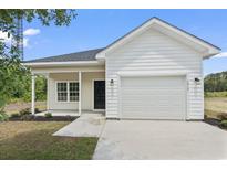 Charming single-story home featuring a well-maintained lawn and an attached two-car garage at 7913 E Highway 19, Loris, SC 29569