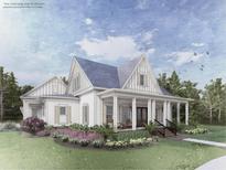 Charming exterior showcasing a covered front porch, beautiful landscaping, and classic architectural details at Lot 3 Makepeace Pl., Pawleys Island, SC 29585