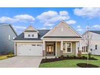 Charming single-Gathering home with a two-car garage and a beautifully landscaped front yard at 5032 Cambria Ct., Little River, SC 29566