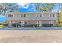 Inviting exterior view of townhome with manicured landscaping, and plenty of parking at 5173 Inlet Garden Ct. # 7A, Murrells Inlet, SC 29576