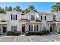 Tan siding townhouse with brick accents, and a small front yard at 111 Maddux Ln. # B, Myrtle Beach, SC 29588