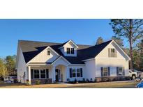 Two-story farmhouse-style home with white siding and gray roof at 2612 Old Charleston Rd., Georgetown, SC 29440