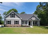 Charming single-story home features a symmetrical design, complemented by a well-manicured lawn, and traditional architectural details at 2612 Old Charleston Rd., Georgetown, SC 29440