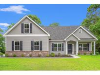 Charming one-story home with gray siding, brick accents, black shutters, and a well-manicured lawn at 2612 Old Charleston Rd., Georgetown, SC 29440