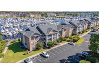 Aerial view of condo building with parking and marina at 4633 Lightkeepers Way # 5-J, Little River, SC 29566