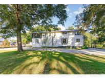 Two-story home with a large front yard and mature trees, offering shade and curb appeal at 4426 Old Kings Hwy., Murrells Inlet, SC 29576