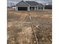 Newly constructed craftsman style home with gray exterior and two car garage at 1806 Mack Rd., Conway, SC 29526