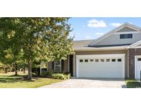 Charming exterior showcasing a two-car garage, lovely landscaping, and a welcoming entrance to the home at 1664 Randor Ct., Myrtle Beach, SC 29579