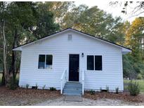 Charming single story home with a symmetrical design, white siding, and a welcoming entrance at 416 S Magnolia Ave., Andrews, SC 29510