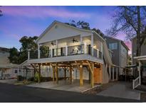 Beautiful elevated beach house with a spacious covered porch perfect for enjoying ocean breezes at night at 6001 - 5721 S Kings Hwy., Myrtle Beach, SC 29575