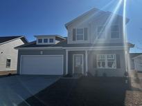 Charming two-story home featuring a welcoming front porch and a pristine two-car garage at 836 Agostino Dr., Myrtle Beach, SC 29579