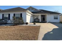 Charming single-story home featuring a two-car garage and welcoming rocking chairs on the front porch at 237 Cloverleaf Dr., Longs, SC 29568