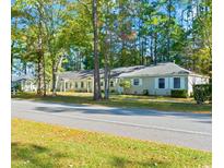 Charming single-story home featuring a classic design and surrounded by mature trees at 6734 Blue Heron Blvd. # 104, Myrtle Beach, SC 29588