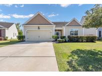 Charming single-story home featuring a well-maintained lawn, two-car garage, and inviting curb appeal at 140 Carolina Oaks Dr., Murrells Inlet, SC 29576