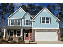 Charming two-story home with blue siding, stone accents, and a bright red front door at 571 Haven View Way, Murrells Inlet, SC 29576
