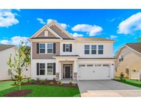 Beautiful two-story home featuring a two-car garage and well-manicured lawn at 5024 Cambria Ct., Little River, SC 29566