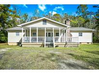 One-story house with a large front porch and surrounding trees at 872 Jackson Circle, Conway, SC 29526