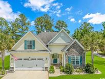 Charming single-Gathering home with a well-manicured lawn and beautiful landscaping at 4157 Charleston Oaks Dr, Loris, SC 29569