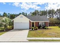 Charming single-story home featuring a well-maintained lawn, brick accents, and attached two-car garage at 4659 East Walkerton Rd., Myrtle Beach, SC 29579