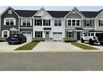 Charming townhouses with individual garages and modern exteriors provide ample parking space at 2050 Nw Parow Ln Nw # E, Calabash, NC 28467