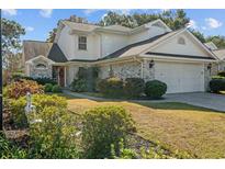 Charming home with a two-car garage, manicured landscaping, and a welcoming front entrance at 2063 Ayershire Ln., Myrtle Beach, SC 29575