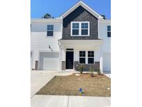 Charming townhome with white siding, shingle accent, a one-car garage, and a well-maintained lawn at 796 Nw Palm Frond Way # 47, Calabash, NC 28467