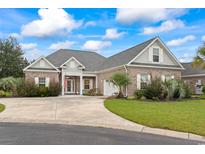 Inviting brick home with manicured lawn, elegant columns, and a spacious driveway for convenient parking at 116 Ocean Sands Ct., Myrtle Beach, SC 29579
