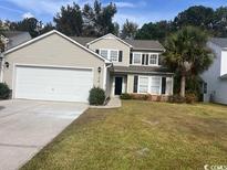 Charming two-story home with a well-manicured lawn and a two-car garage at 156 Weeping Willow Dr., Myrtle Beach, SC 29579
