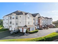 View of condo complex with garage parking, manicured lawn, and neutral color palette at 2241 Waterview Dr. # 437, North Myrtle Beach, SC 29582