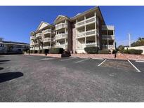 Spacious condo building featuring multiple balconies and ample parking at 2805 N Ocean Blvd. # 107, Myrtle Beach, SC 29577