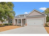 Charming single-Gathering home featuring neutral siding, a two-car garage, and a well-manicured front yard at 608 Britt St., Georgetown, SC 29440