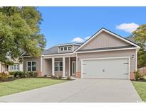 Charming one-story home with a two-car garage, manicured lawn, and inviting covered entry at 608 Britt St., Georgetown, SC 29440