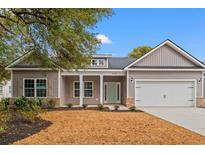 Charming single-Gathering home with gray siding, a two-car garage and well-maintained landscaping at 608 Britt St., Georgetown, SC 29440